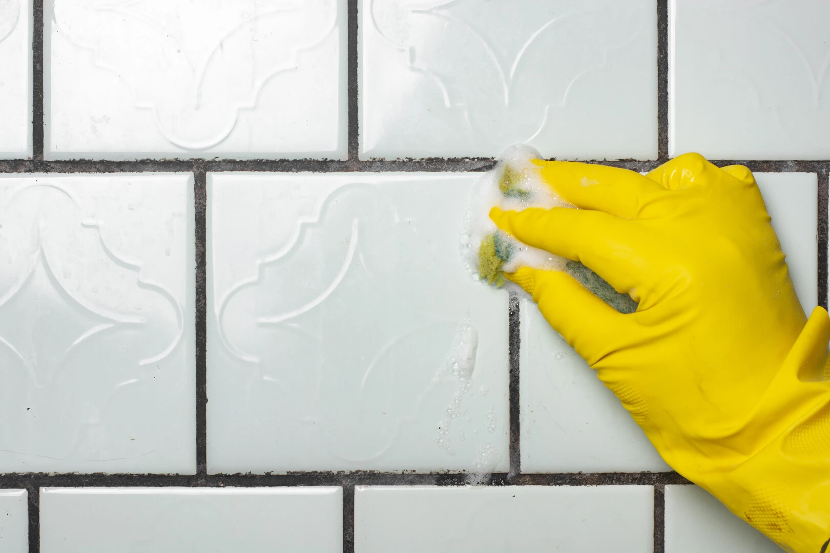 How to Install tiles with tile adhesive - Cleaning the tiles to remove excess grout stains and tile adhesive