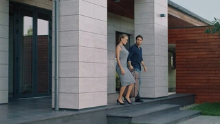 Exterior area solutions for tile adhesive grouting waterproofing for beautiful tiles, couple walking outside of the house corporate look business man and woman