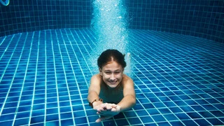 Swimming Pool Tile Adhesive and grout solutions, girl swimming under water in pool, blue waterproofing swimming pool solutions